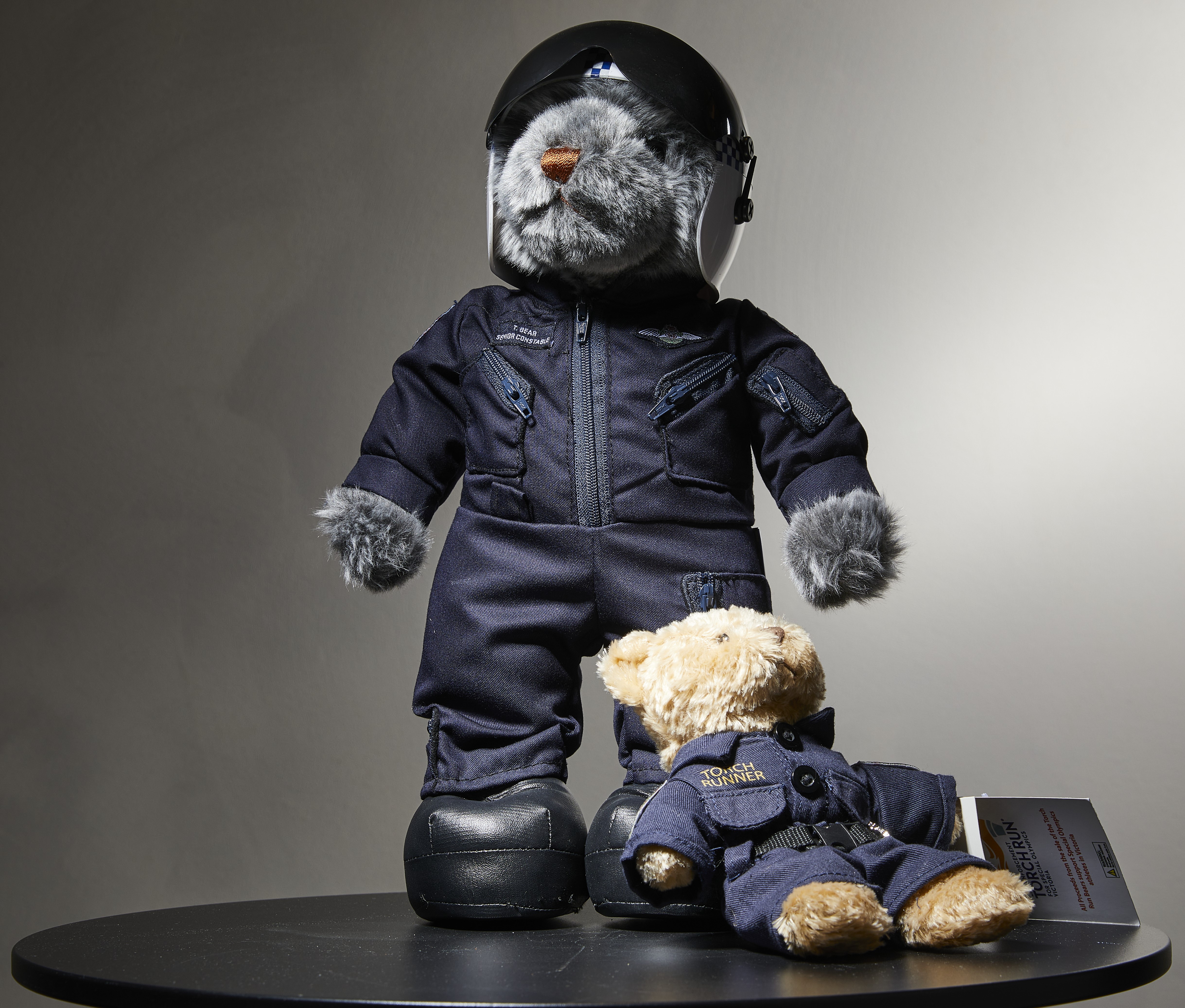 A photo depicting two teddy bears dressed as police officers.